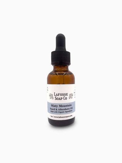 Bottle of Misty Mountain Beard & Aftershave Oil with natural ingredients on a wooden surface